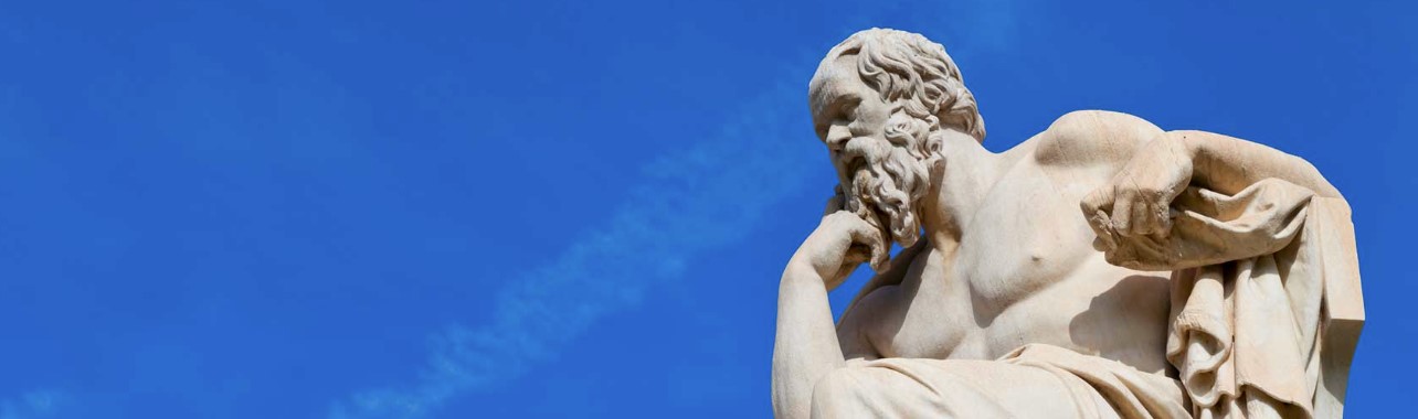 Statue of Socrates against a blue sky